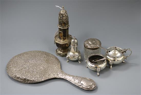 A silver sugar castor, three silver condiments, a toilet jar and three spoons.